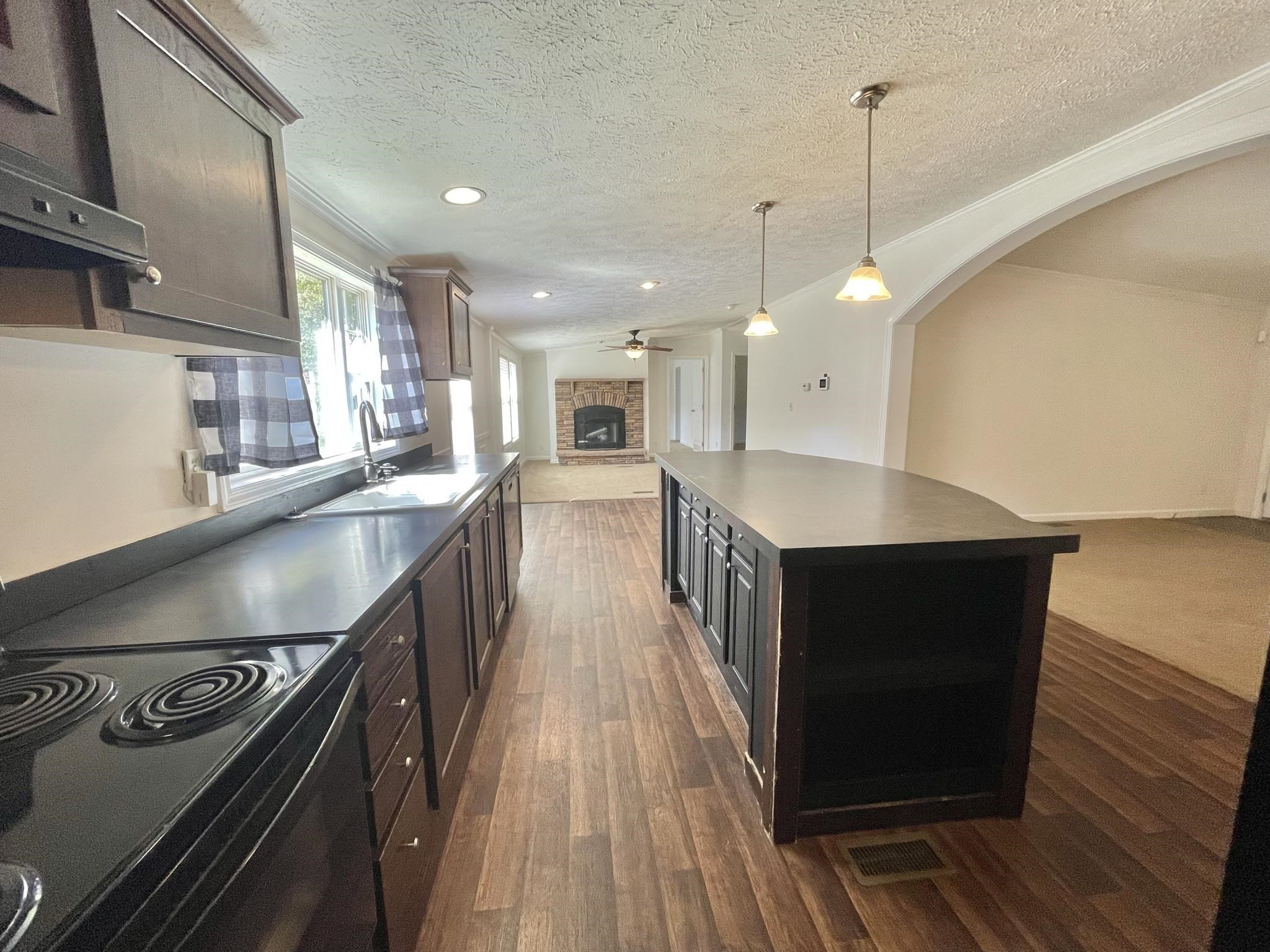 45 Divine Lane Roxboro, NC 27573 - Photo 9 of 28 a kitchen with stainless steel appliances granite countertop a sink a stove and a wooden floors