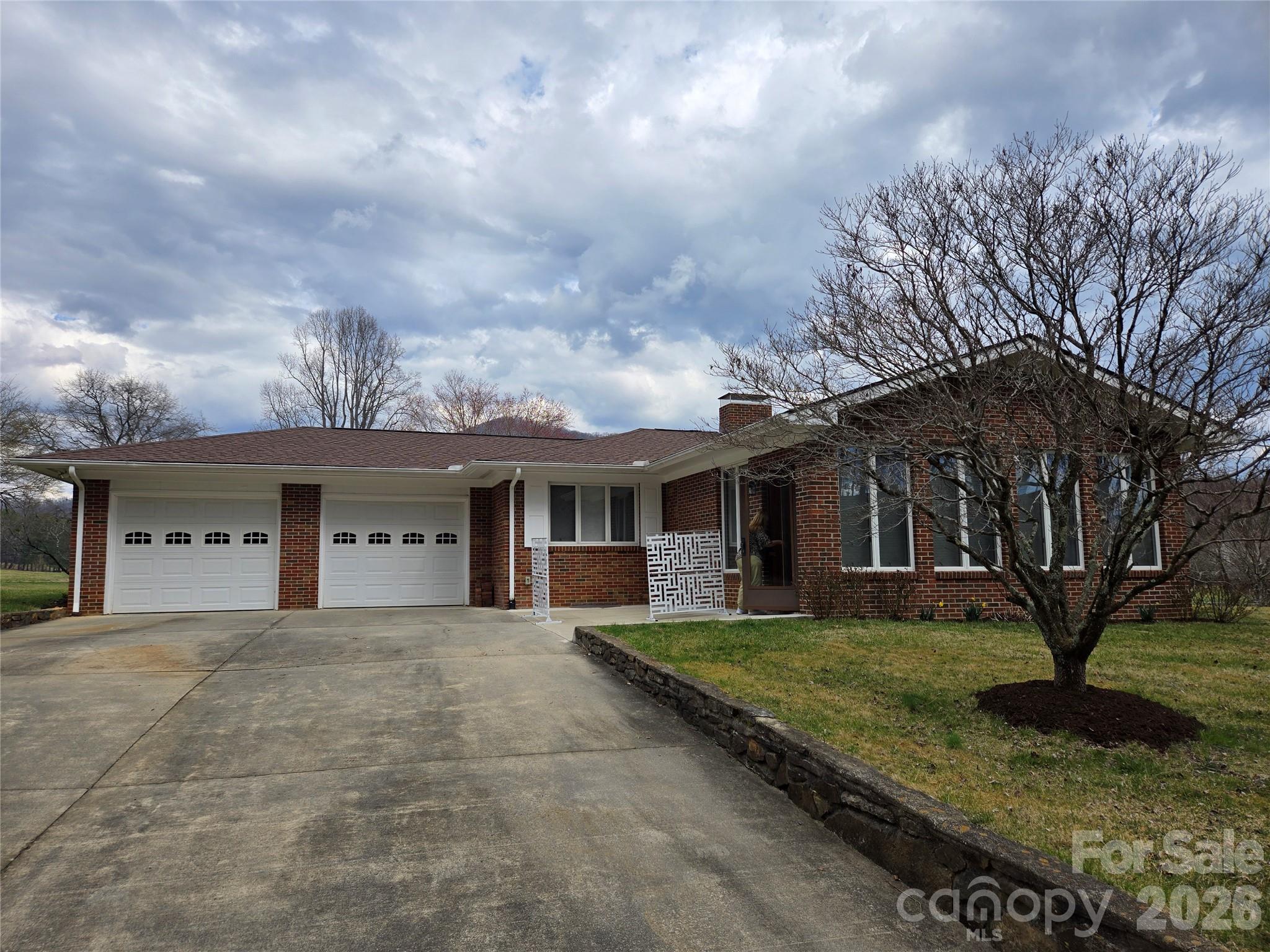 100 Chapel Road Black Mountain, NC 28711 - Photo 1 of 30 a view of a white house with a big yard and large tree