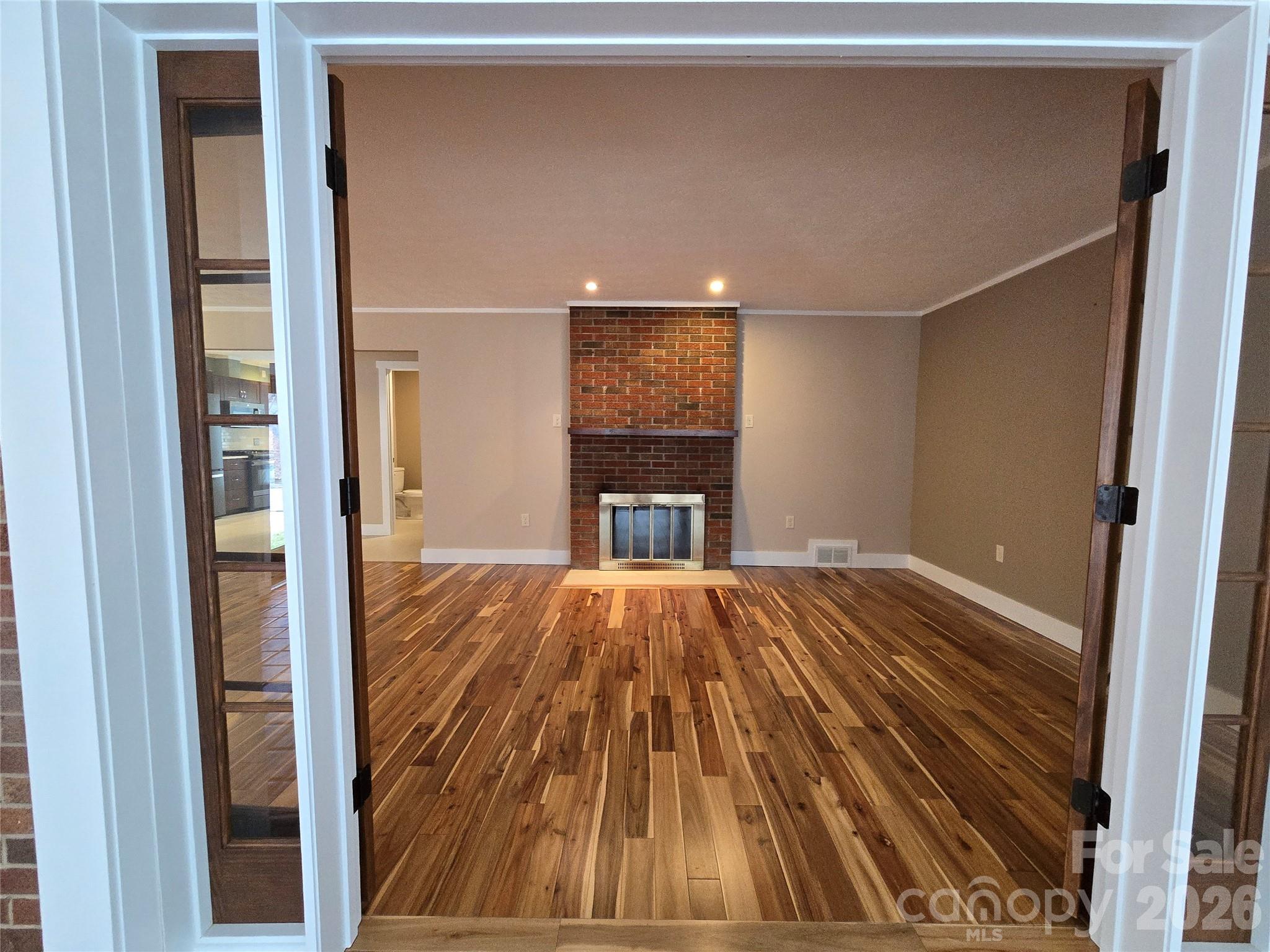 100 Chapel Road Black Mountain, NC 28711 - Photo 15 of 30 a view of empty room with wooden floor and fireplace