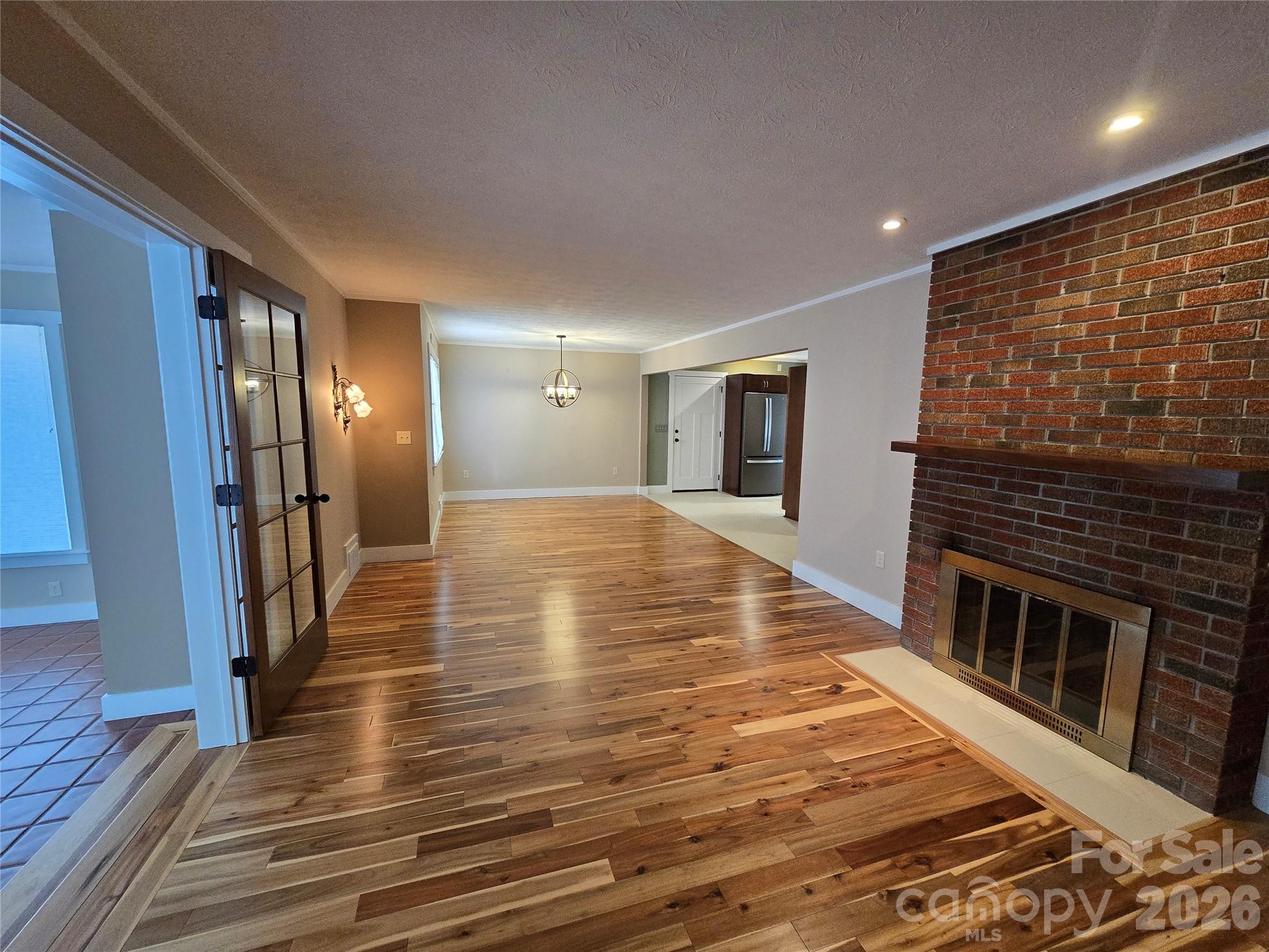 100 Chapel Road Black Mountain, NC 28711 - Photo 16 of 30 a view of a hallway with wooden floor and a fireplace