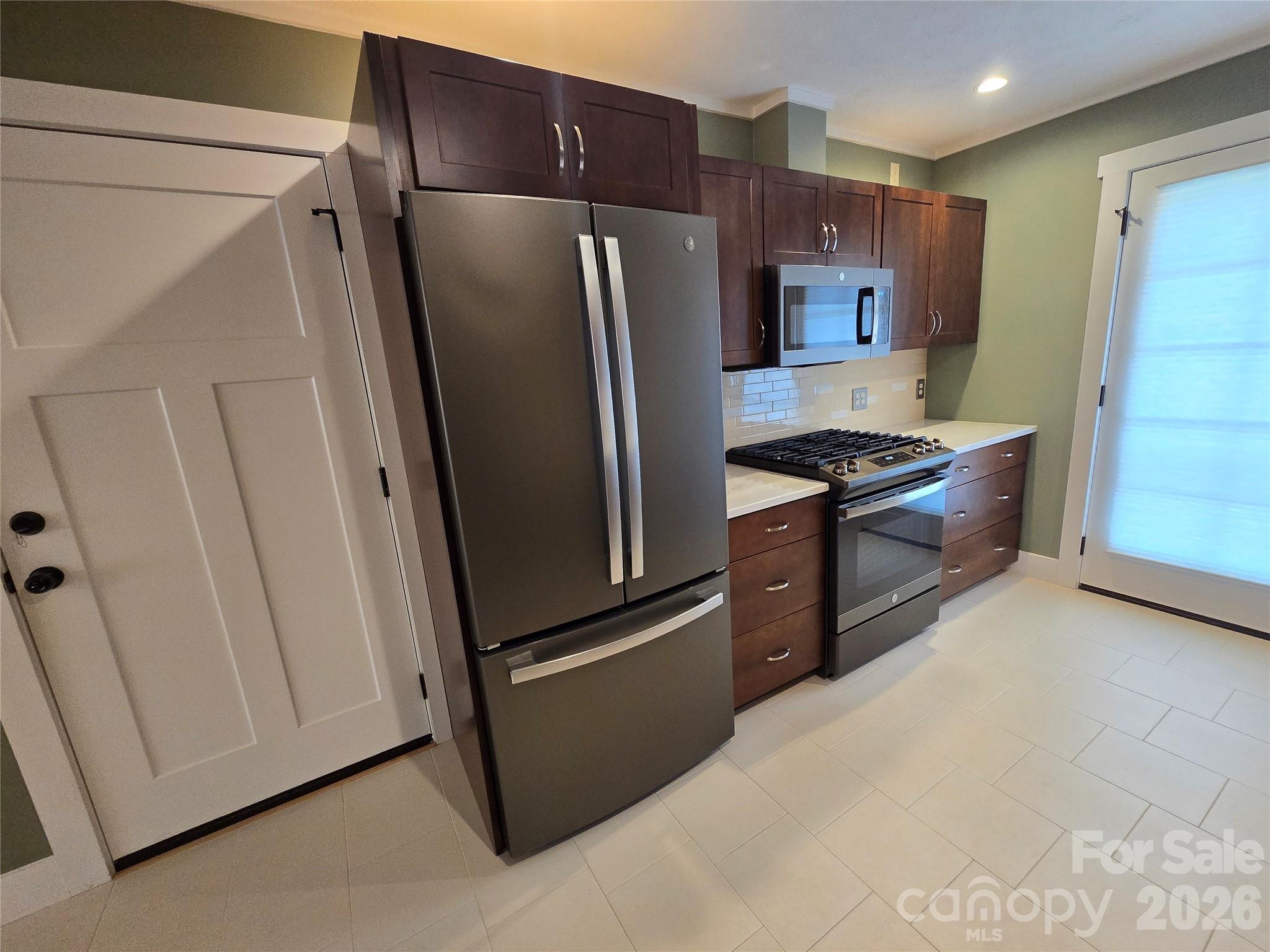 100 Chapel Road Black Mountain, NC 28711 - Photo 18 of 30 a kitchen with stainless steel appliances granite countertop a refrigerator and a stove
