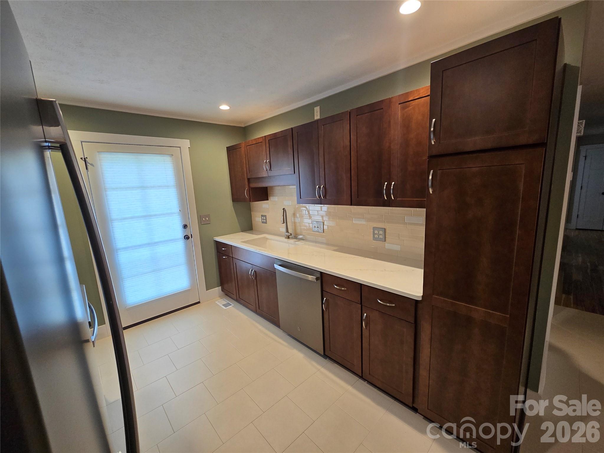 100 Chapel Road Black Mountain, NC 28711 - Photo 19 of 30 a kitchen with a refrigerator sink and cabinets