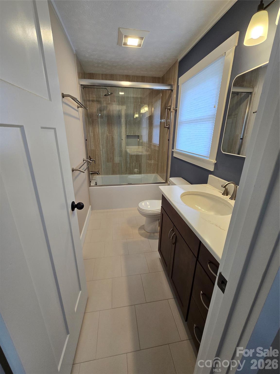 100 Chapel Road Black Mountain, NC 28711 - Photo 22 of 30 a bathroom with a sink a toilet a mirror and shower