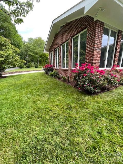 100 Chapel Road Black Mountain, NC 28711 - Photo 4 of 30 a view of a house with a backyard and garden