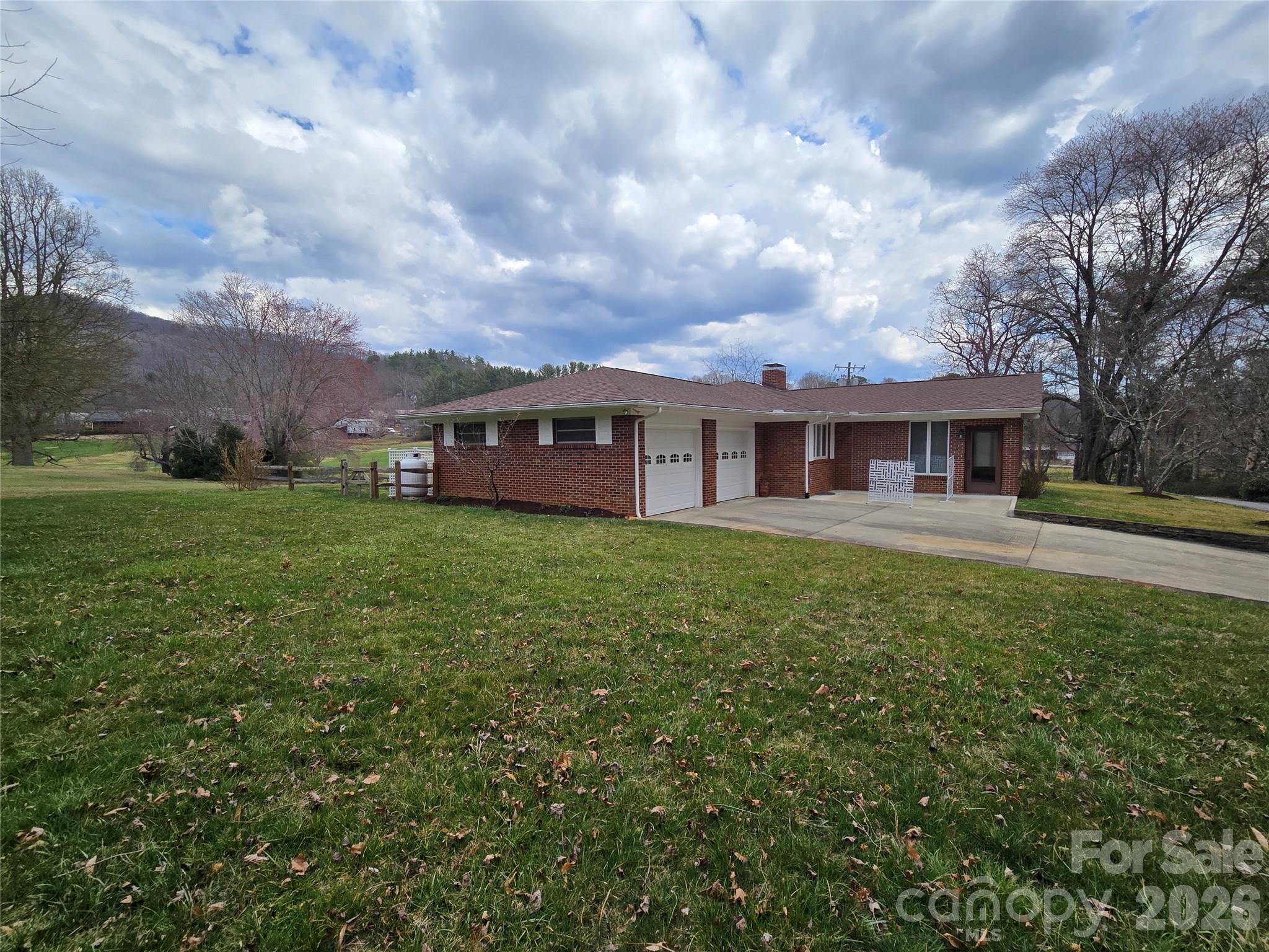 100 Chapel Road Black Mountain, NC 28711 - Photo 6 of 30 a view of a house with a big yard and large trees