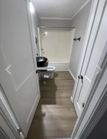 a view of a room with wooden floor