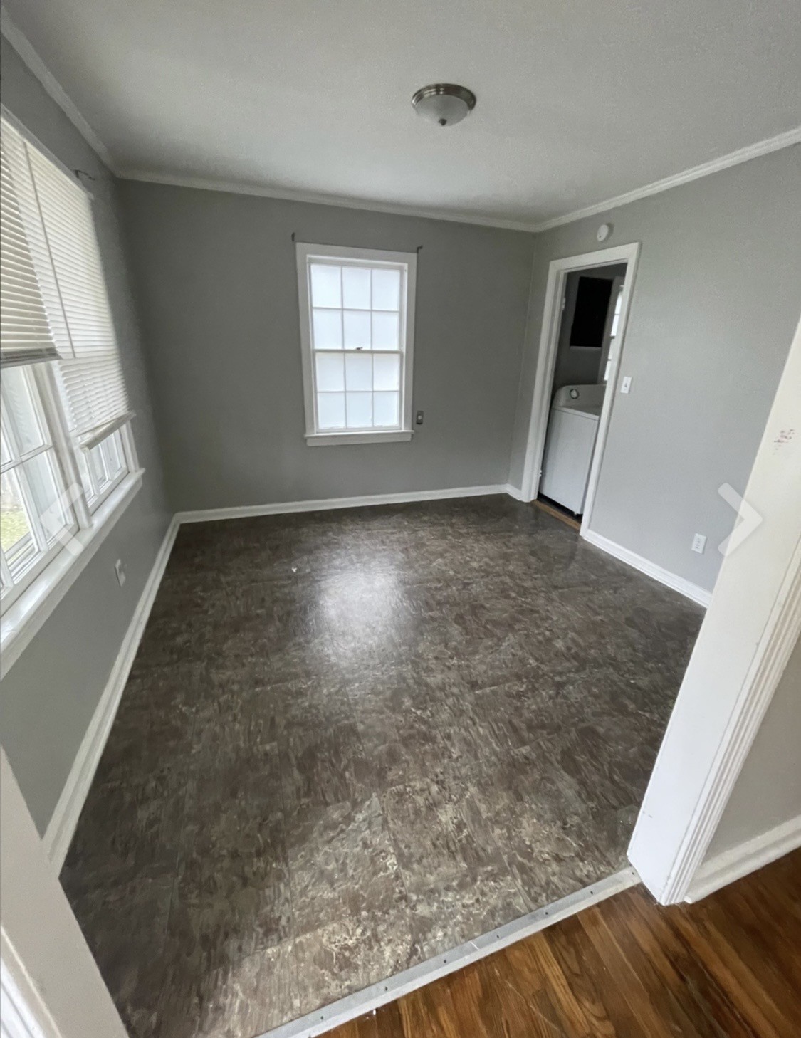 635 Cleveland Street Pulaski, TN 38478 - Photo 9 of 10 an empty room with wooden floor and windows
