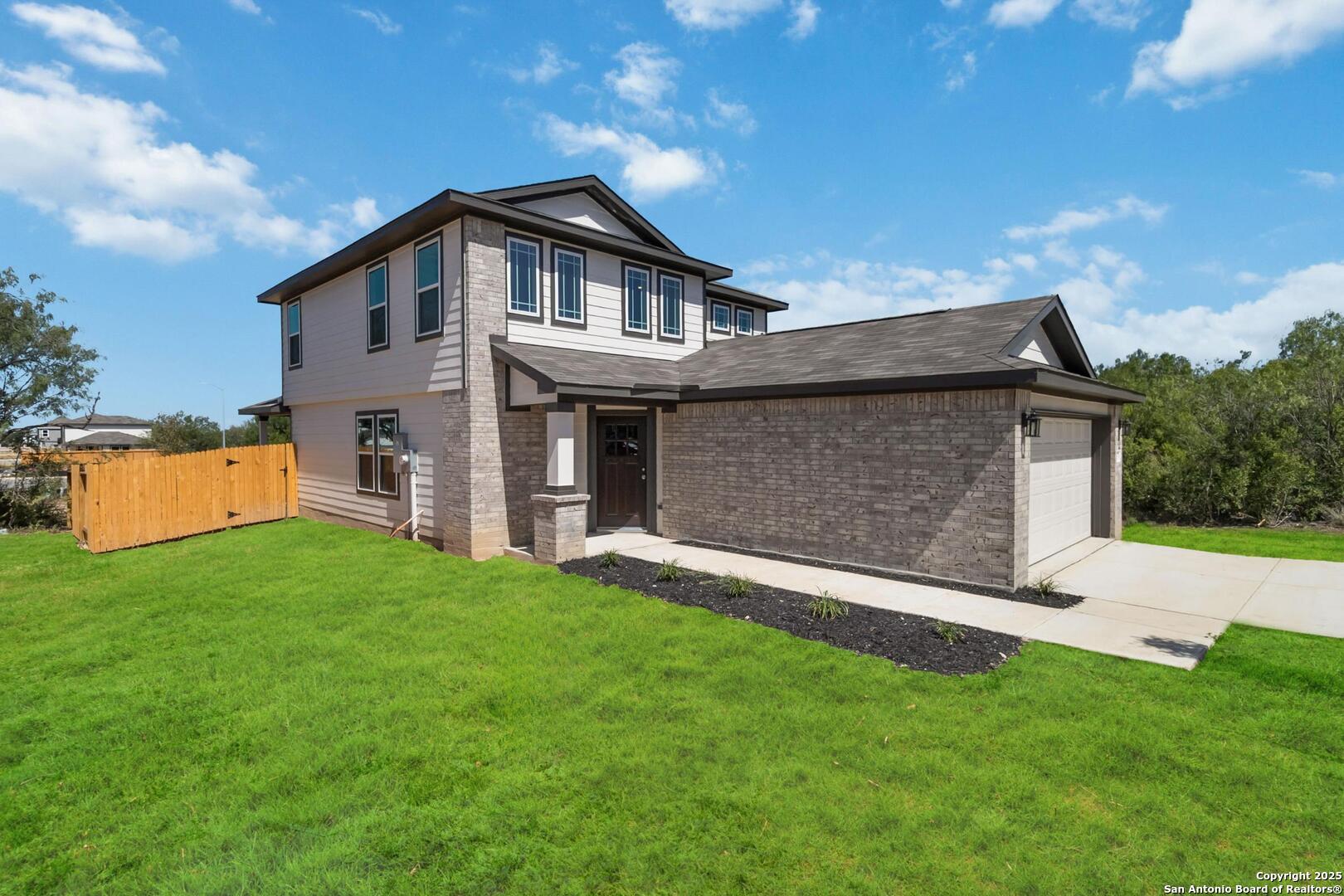 10303 Apple Pie Road San Antonio, TX 78224 - Photo 2 of 31 a front view of a house with a yard and garage