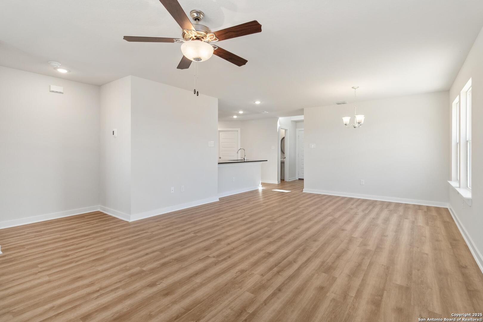 10303 Apple Pie Road San Antonio, TX 78224 - Photo 6 of 31 a view of empty room with wooden floor and fan