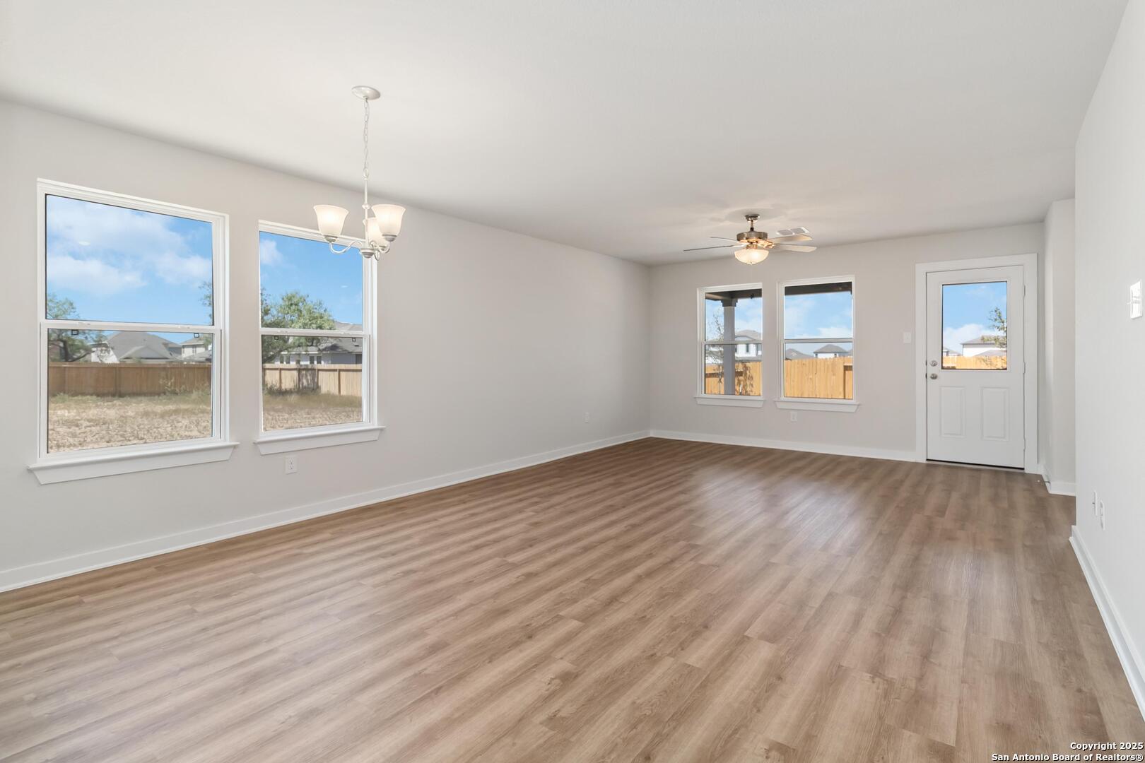 10303 Apple Pie Road San Antonio, TX 78224 - Photo 8 of 31 a view of an empty room with a window and wooden floor