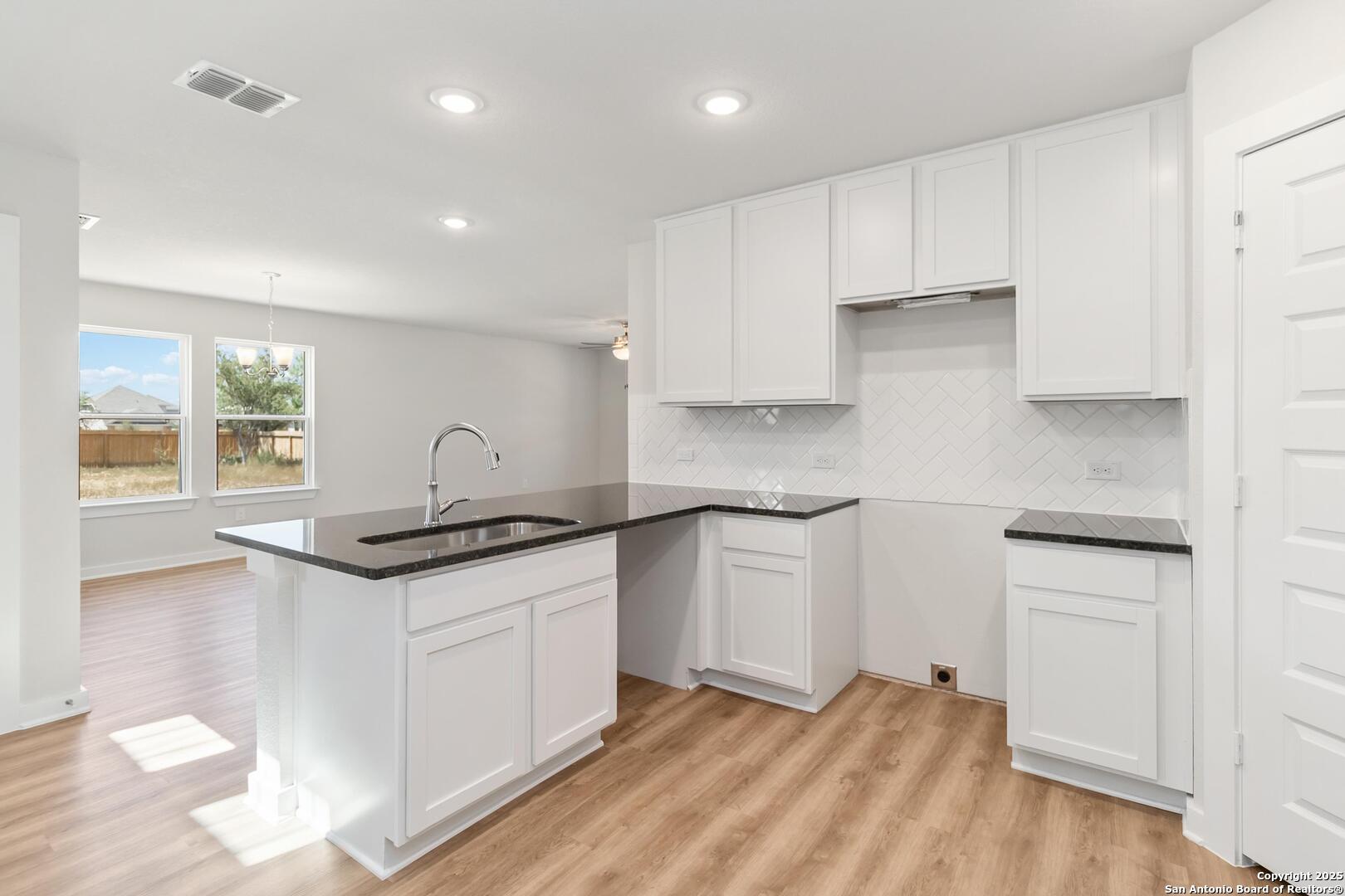 10303 Apple Pie Road San Antonio, TX 78224 - Photo 10 of 31 a kitchen with granite countertop a sink and a stove top oven
