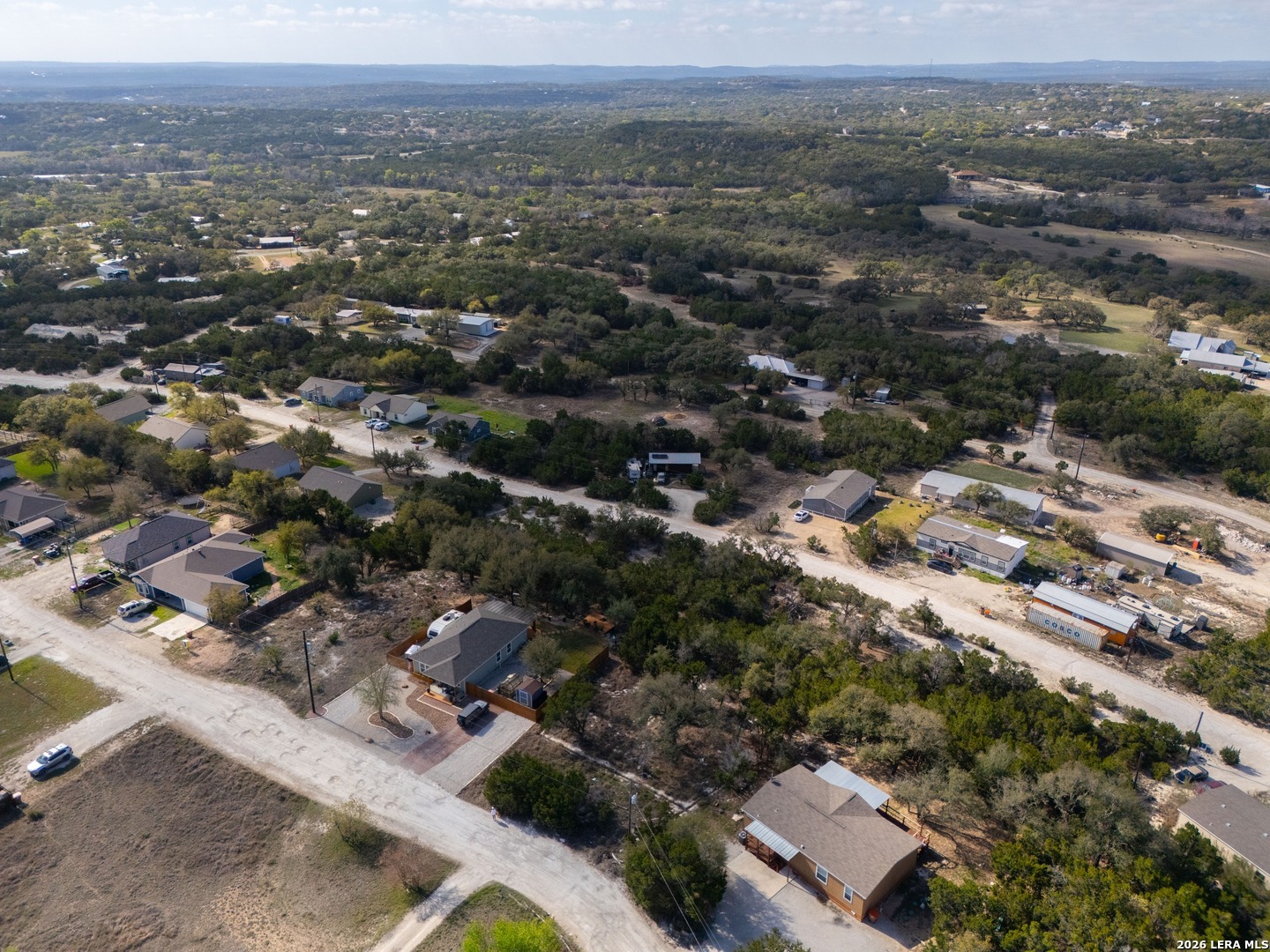 821 Cimarron Spring Branch, TX 78070 - Photo 4 of 10 an aerial view of residential house with parking and mountain view