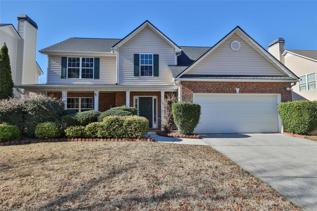 3325 Watson Gate Road Southwest Loganville, GA 30052 - Photo 1 of 1 a front view of a house with a yard