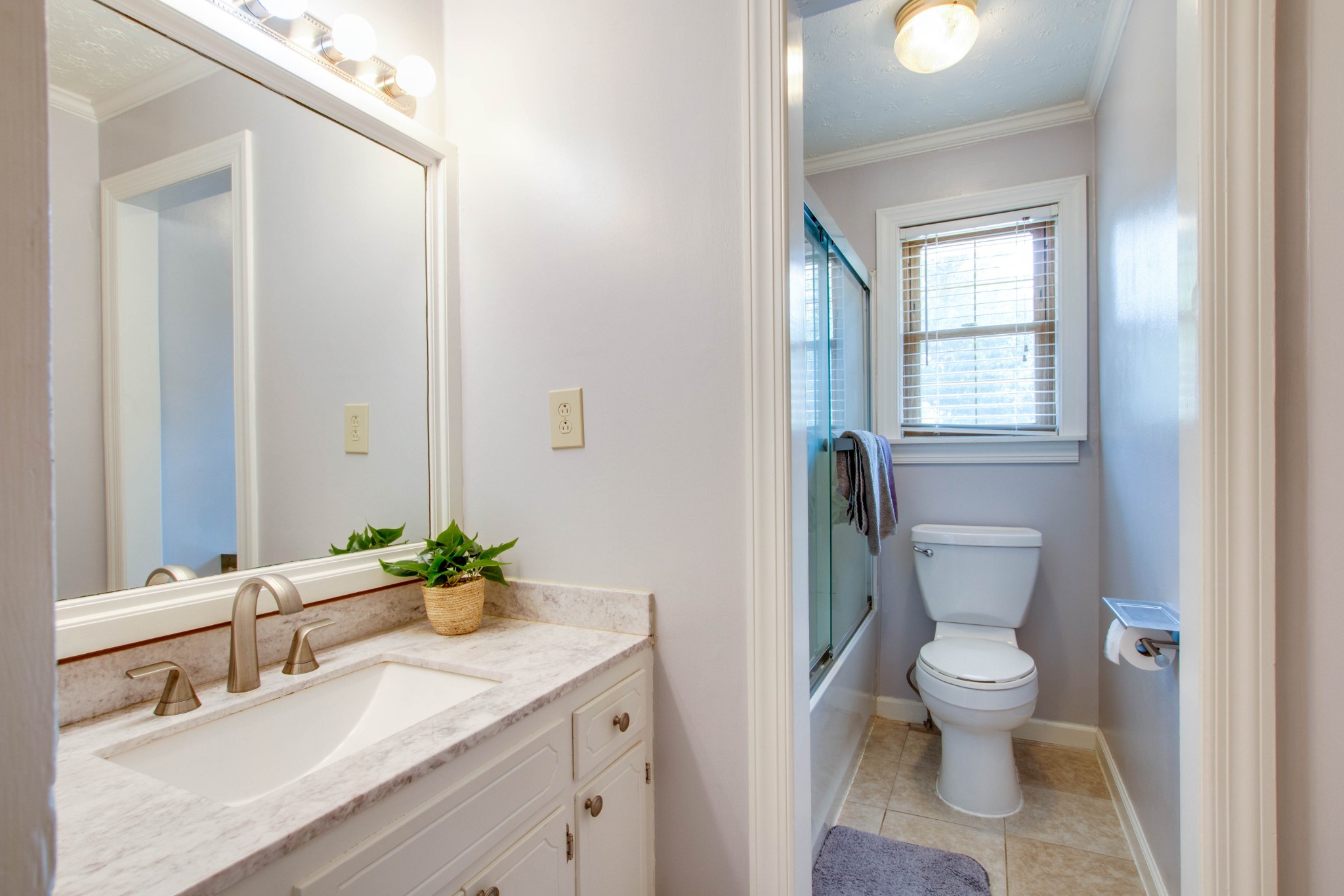 444 S Road Cottontown, TN 37048 - Photo 16 of 30 a bathroom with a granite countertop sink a toilet and a mirror