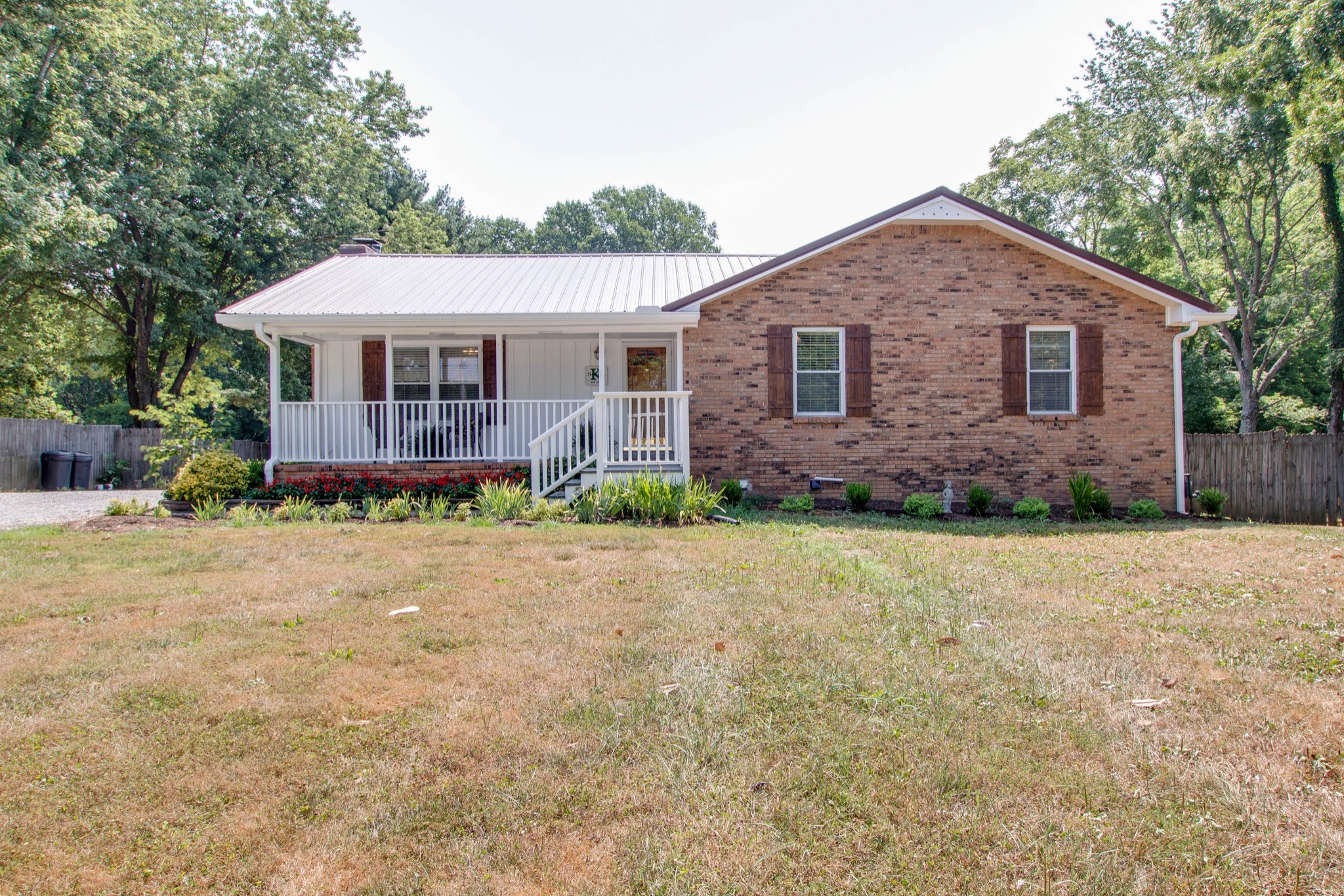 444 S Road Cottontown, TN 37048 - Photo 2 of 30 a front view of a house with a yard and large trees