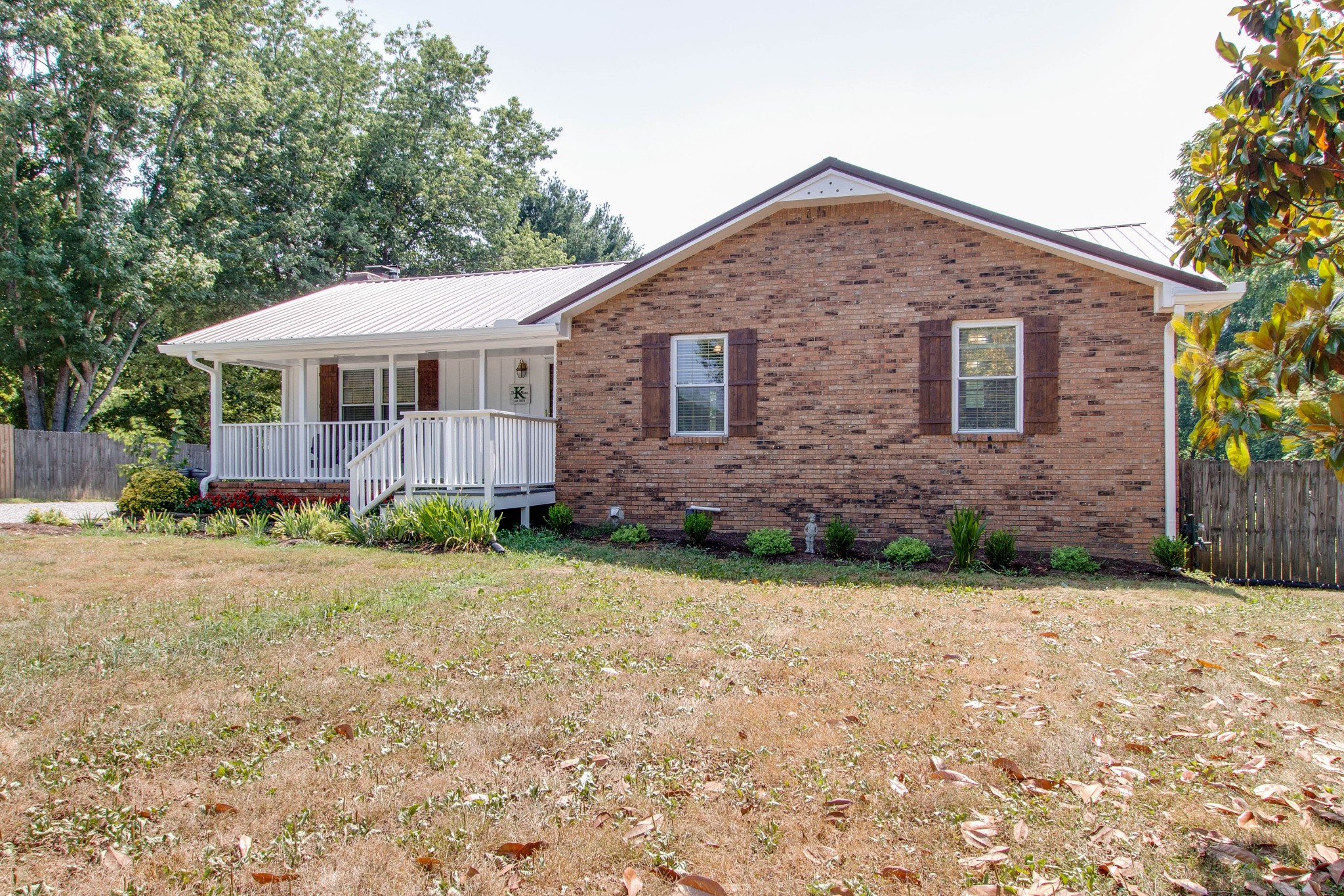 444 S Road Cottontown, TN 37048 - Photo 3 of 30 a front view of a house with garden