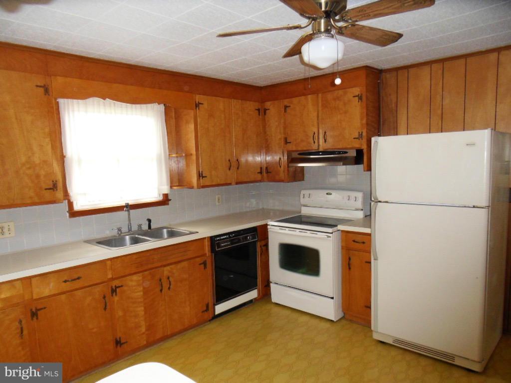 5880 Cloverdale Road Hurlock, MD 21643 - Photo 14 of 30 a kitchen with stainless steel appliances granite countertop a stove a sink and a refrigerator