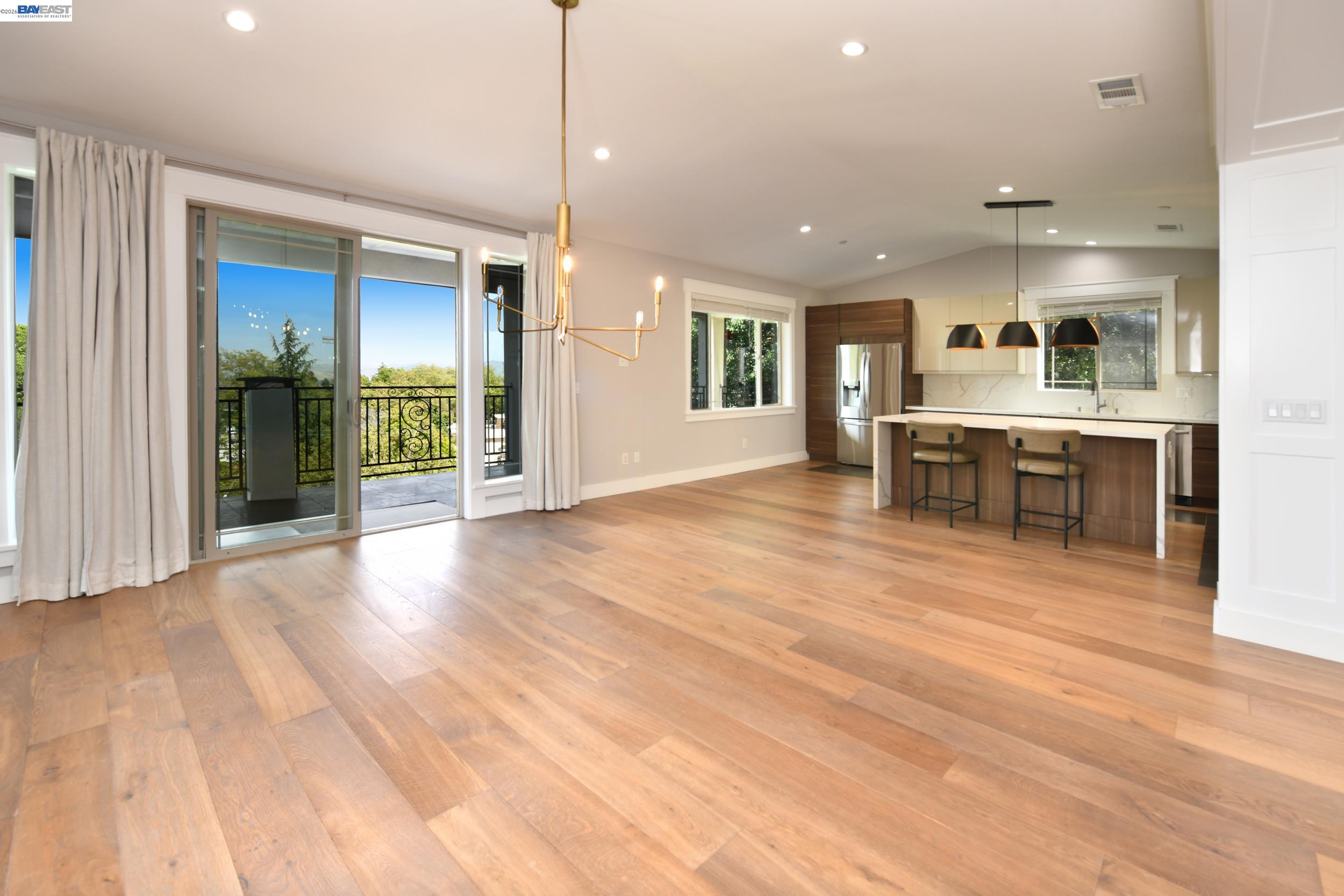 1516 Pleasant Hill Road Lafayette, CA 94549 - Photo 2 of 38 a view of a kitchen with kitchen island granite countertop wooden floor and a refrigerator