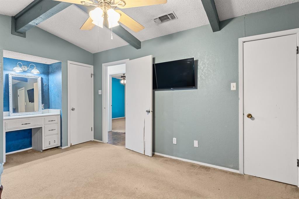 505 Pinewood Lane Hewitt, TX 76643 - Photo 18 of 38 Room with vaulted ceiling, exposed beams, and a ceiling fan