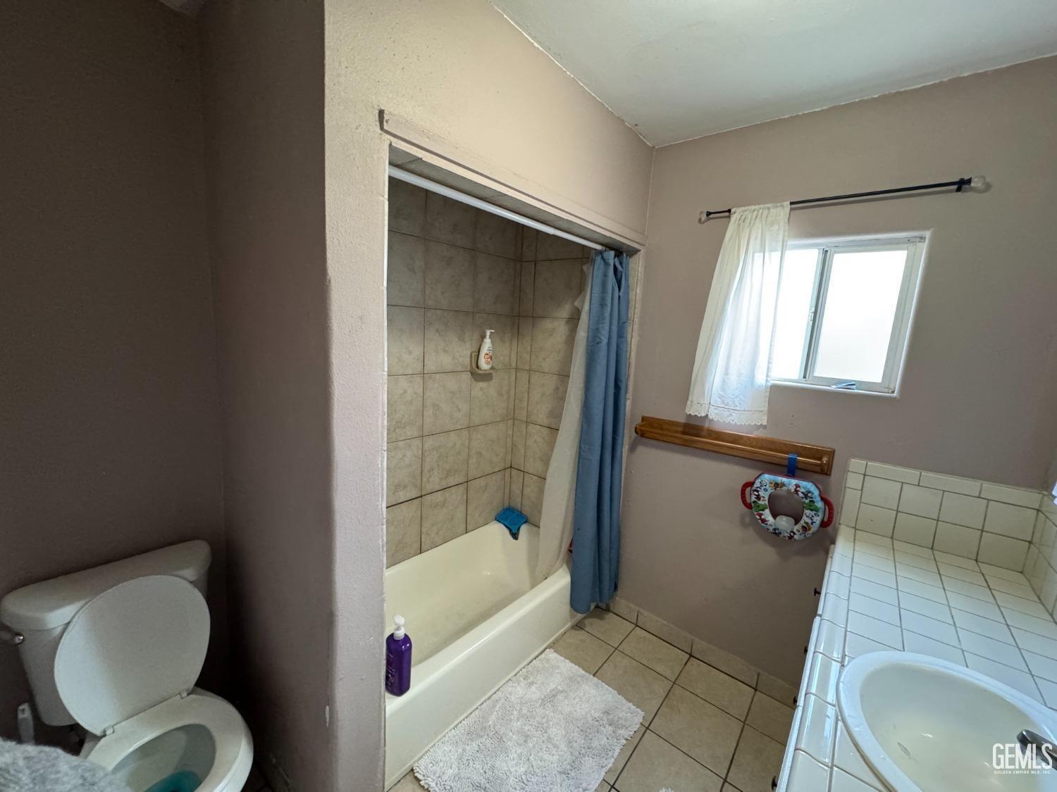 Undisclosed Address Bakersfield, CA 93305 - Photo 11 of 13 a bathroom with a toilet and a shower