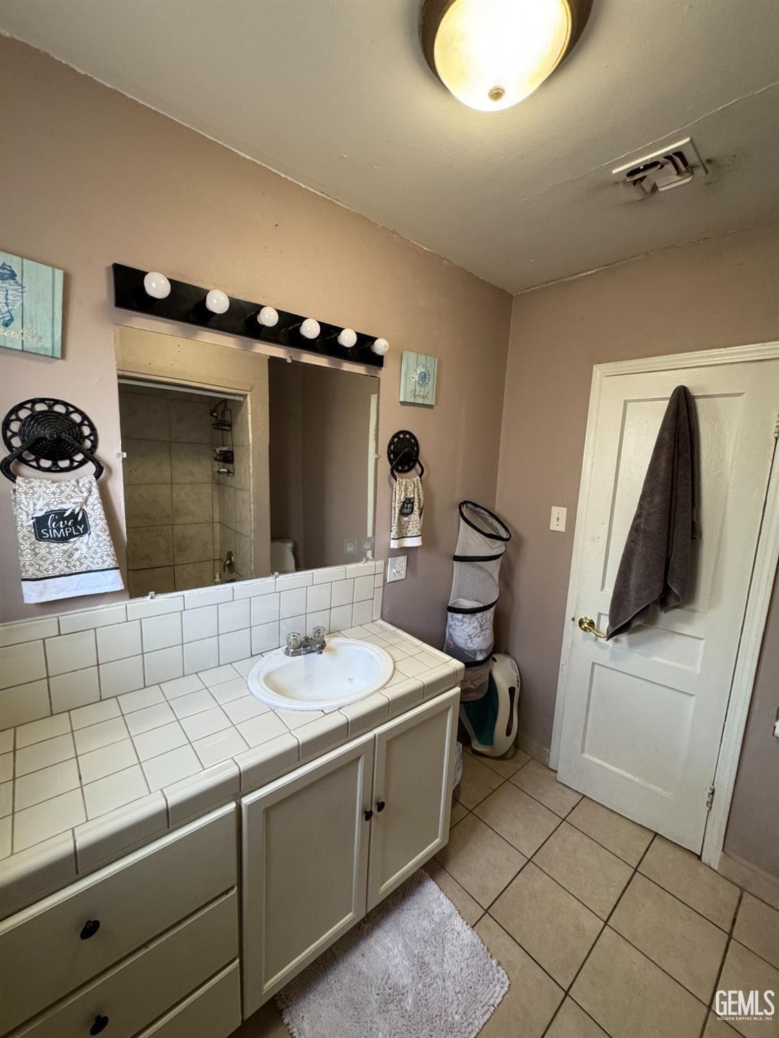 Undisclosed Address Bakersfield, CA 93305 - Photo 12 of 13 a bathroom with a sink and a mirror