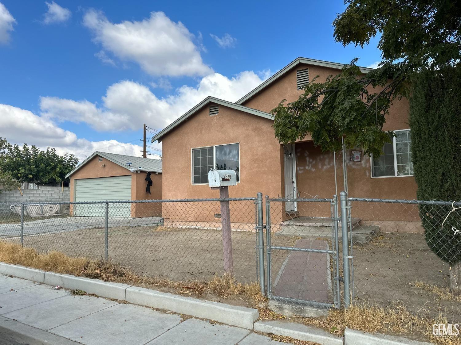 Undisclosed Address Bakersfield, CA 93305 - Photo 2 of 13 a view of a house with a yard