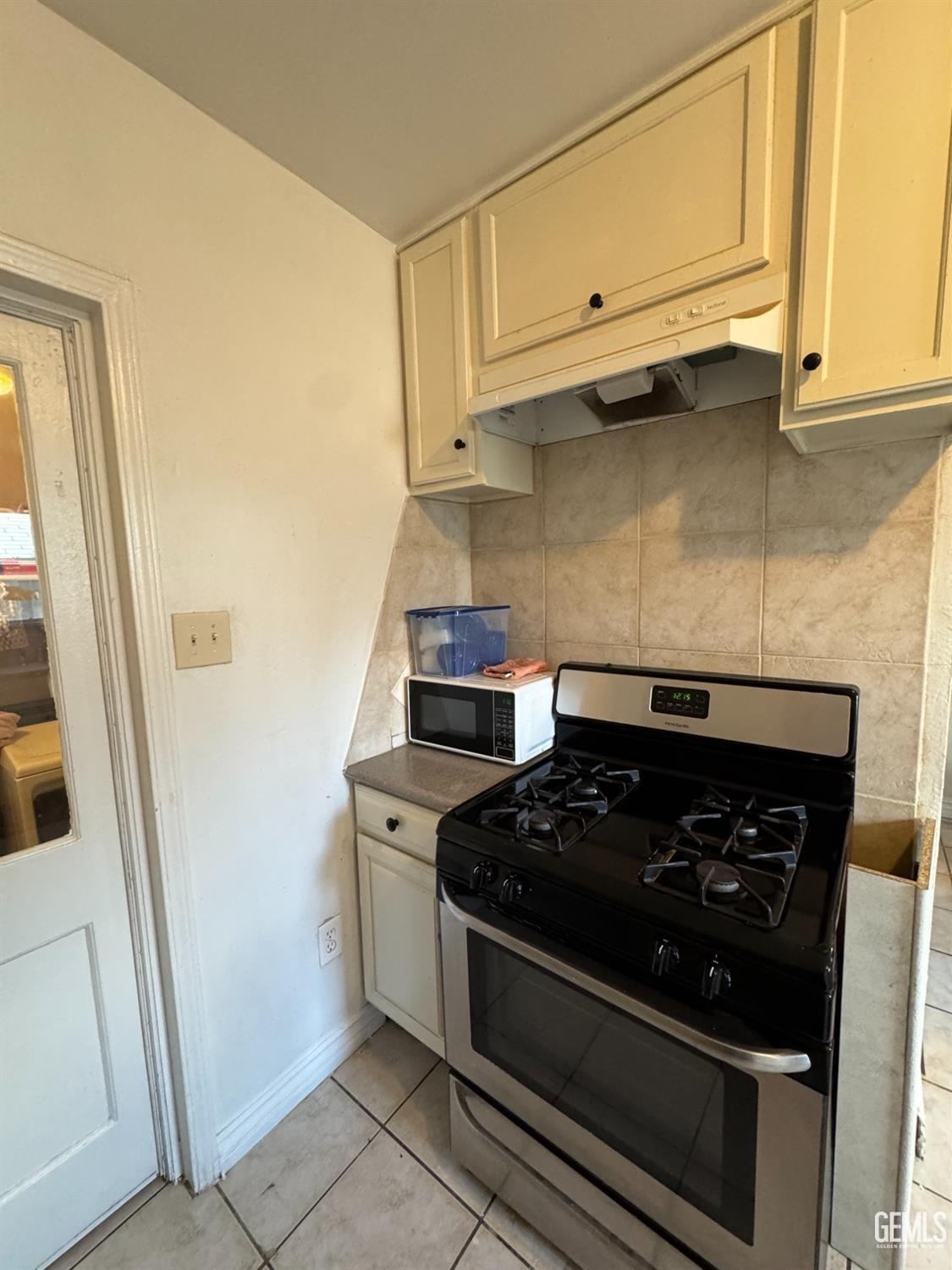 Undisclosed Address Bakersfield, CA 93305 - Photo 7 of 13 a kitchen with stainless steel appliances granite countertop white cabinets and a stove