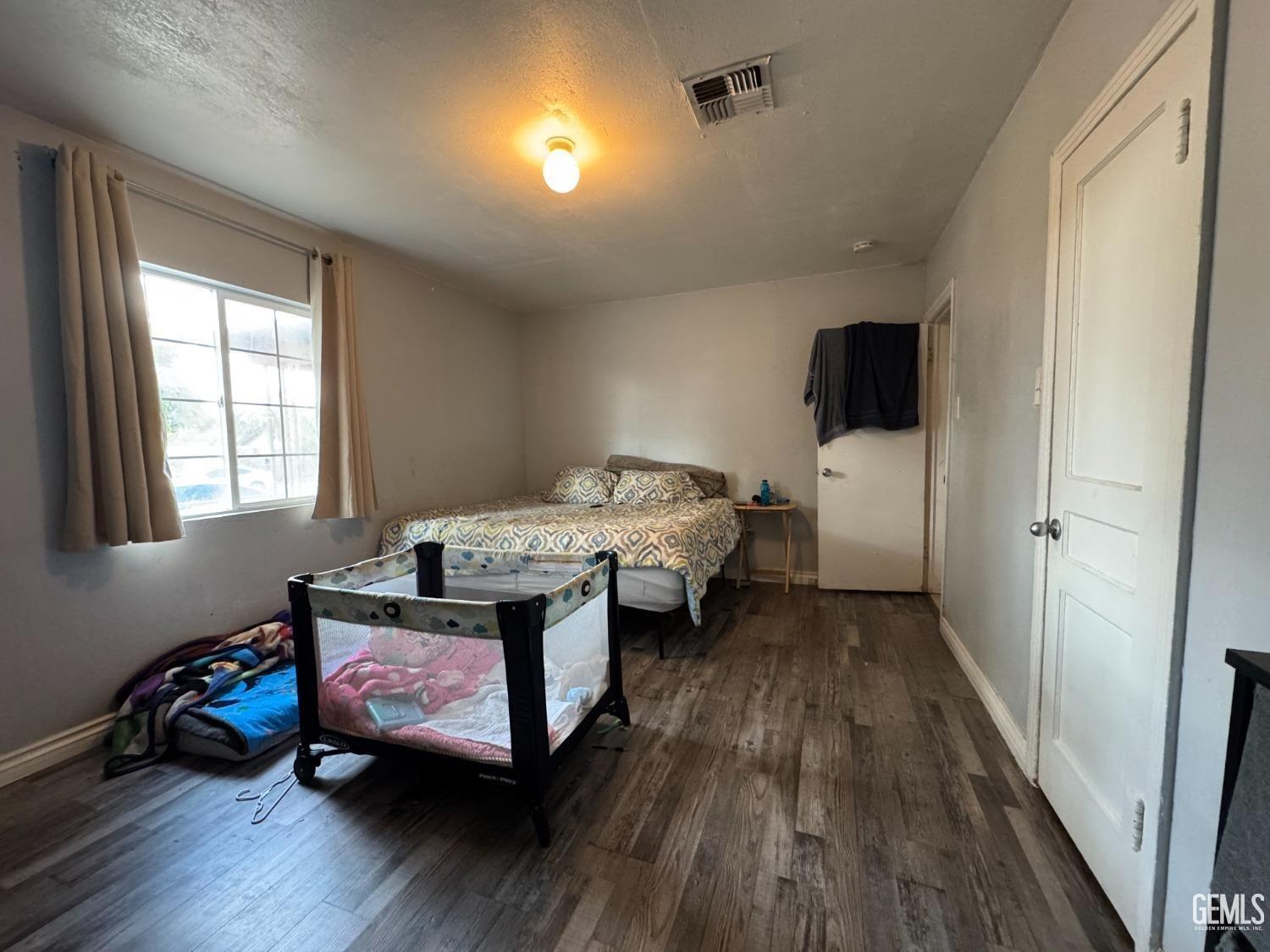 Undisclosed Address Bakersfield, CA 93305 - Photo 10 of 13 a bedroom with furniture and a wooden floor
