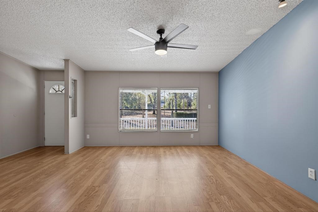 2744 Roy Sikes Road Hilliard, FL 32046 - Photo 11 of 97 a view of an empty room with wooden floor and a window
