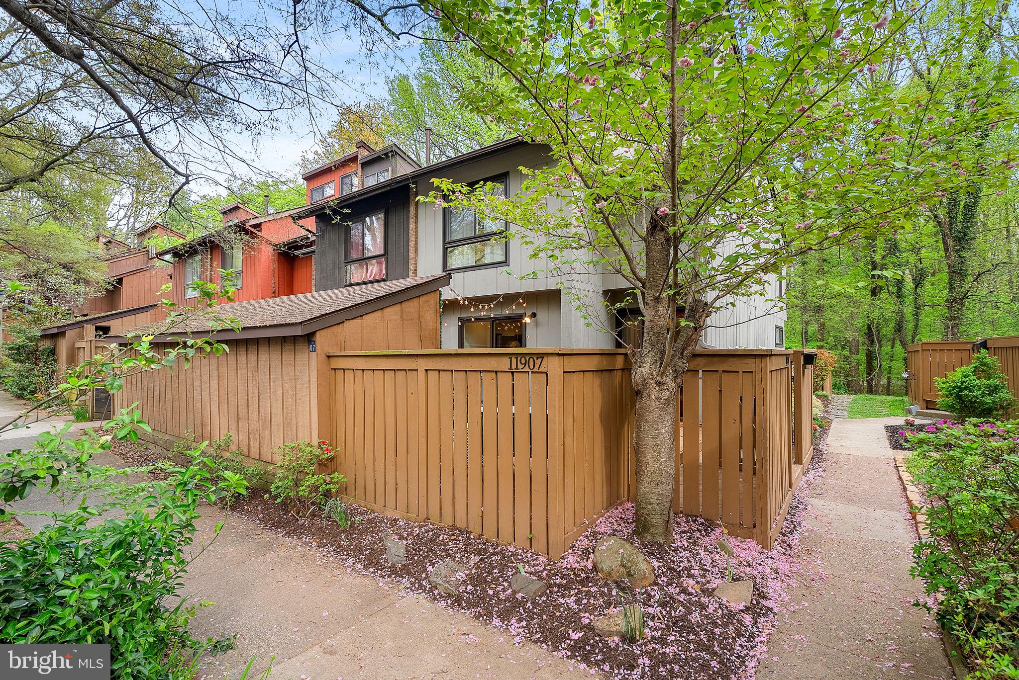 11907 Escalante Court Reston, VA 20191 - Photo 1 of 4 a front view of a house with garden