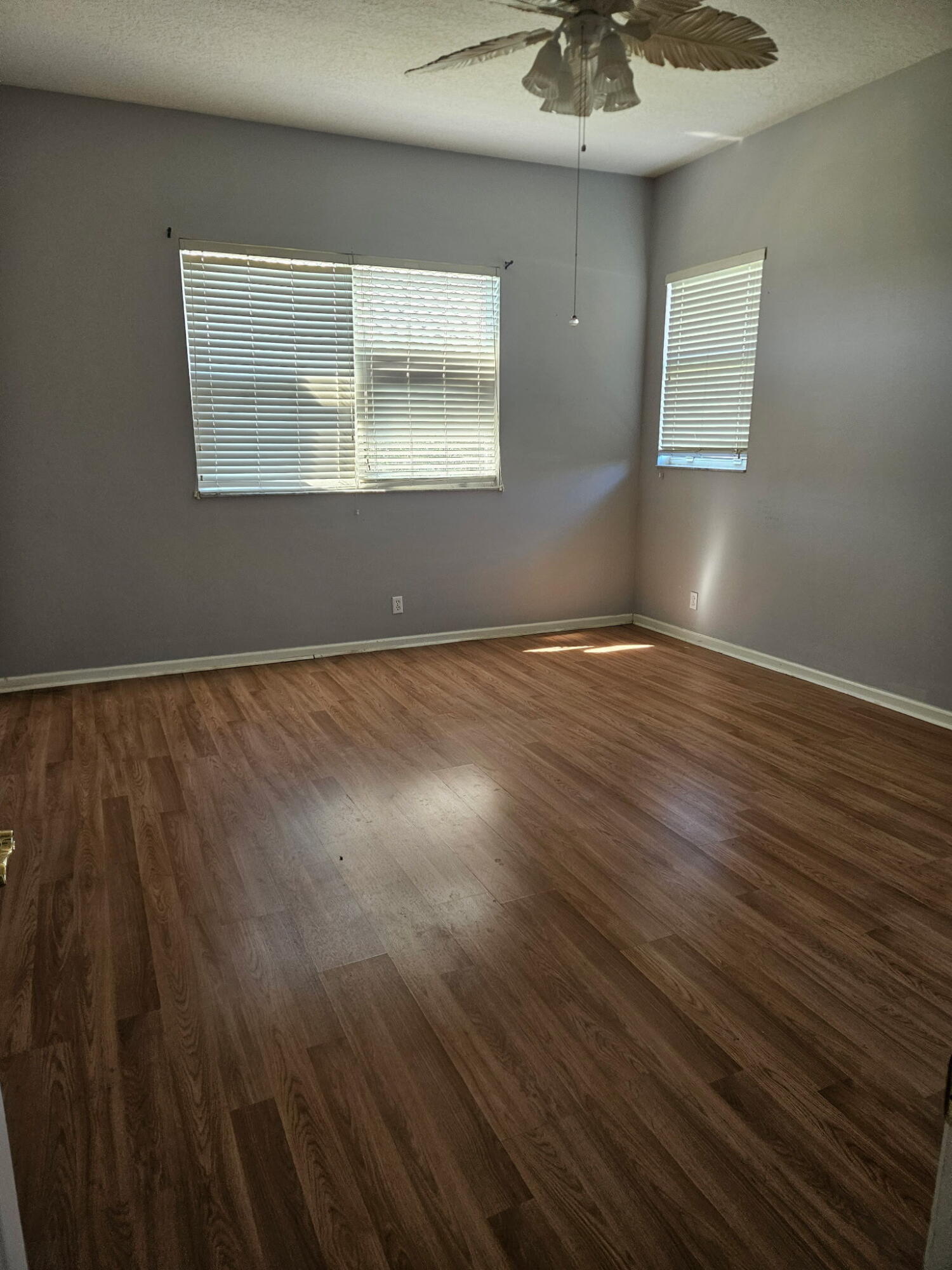 406 Springview Loop Port St. Lucie, FL 34986 - Photo 17 of 23 an empty room with wooden floor and windows