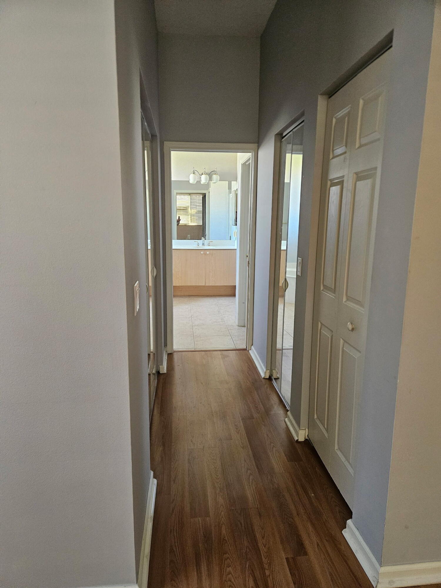 406 Springview Loop Port St. Lucie, FL 34986 - Photo 18 of 23 a view of a hallway with wooden floor