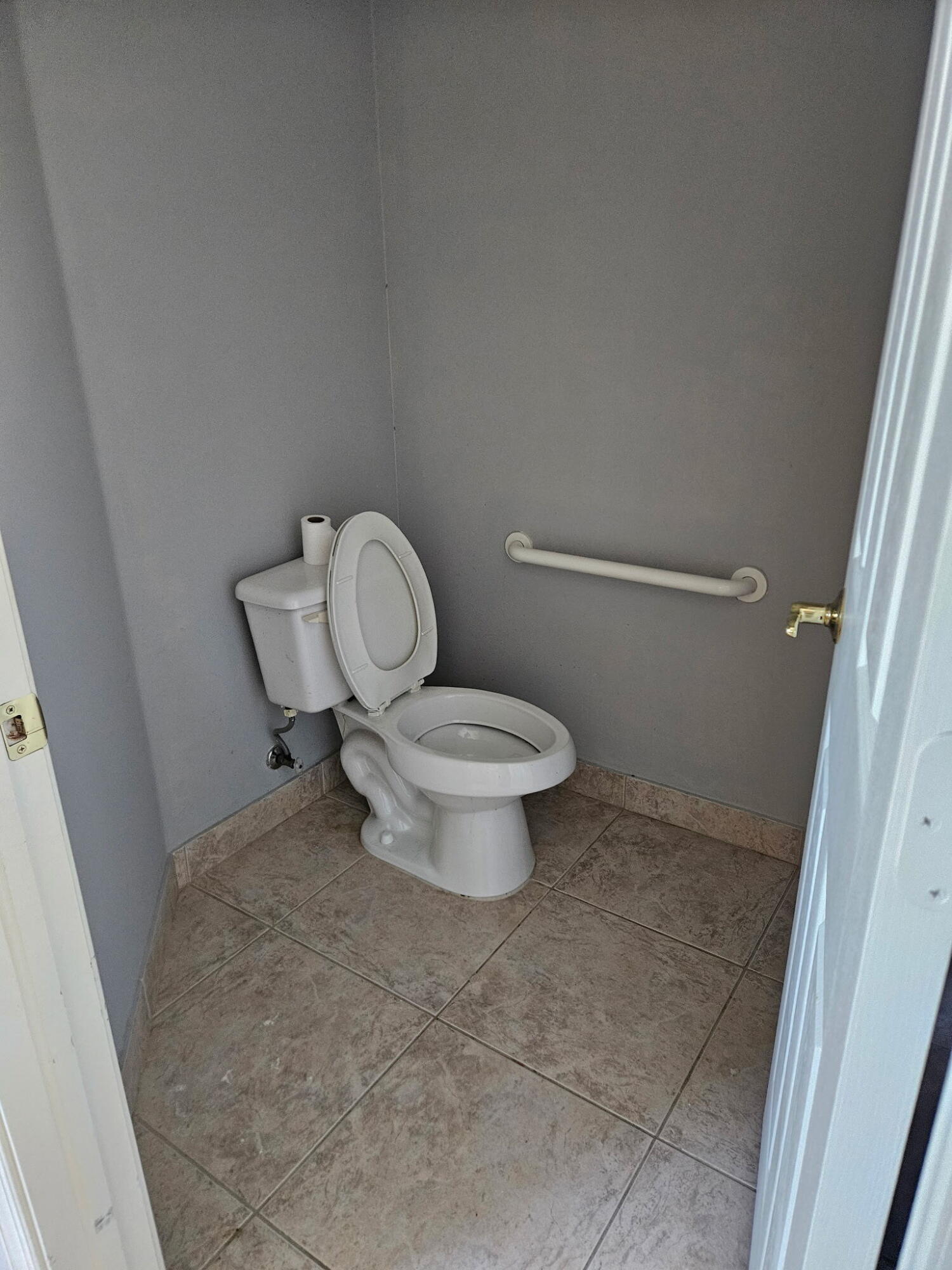 406 Springview Loop Port St. Lucie, FL 34986 - Photo 19 of 23 a white toilet sitting next to a white cabinet