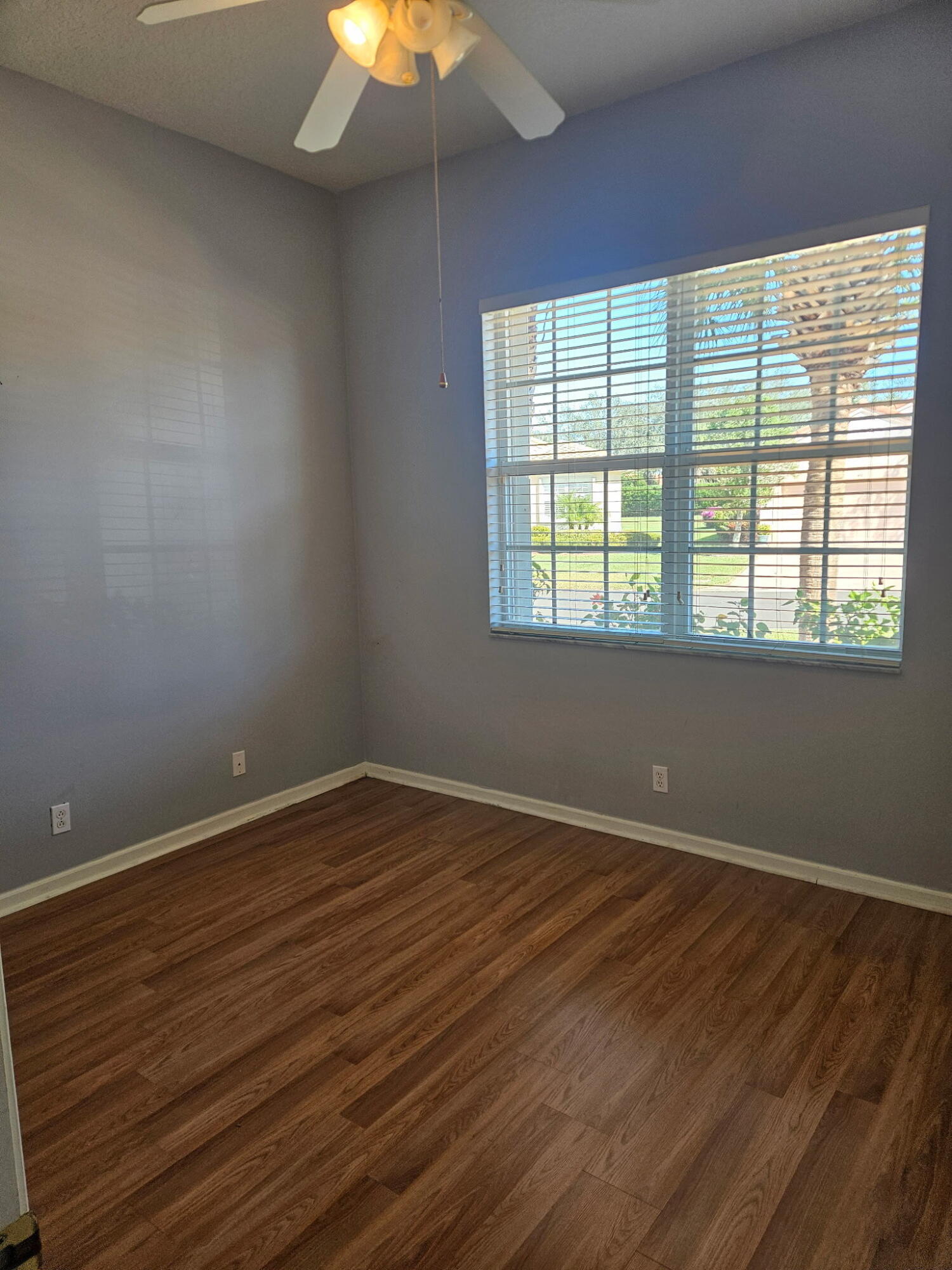 406 Springview Loop Port St. Lucie, FL 34986 - Photo 5 of 23 a view of an empty room with wooden floor and a window