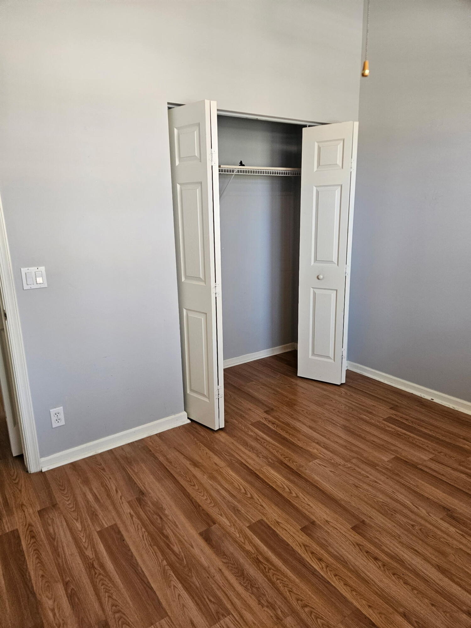 406 Springview Loop Port St. Lucie, FL 34986 - Photo 6 of 23 an empty room with wooden floor and entrance