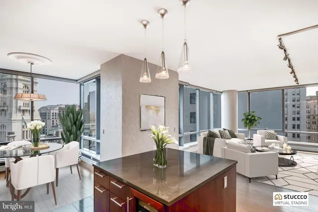 a open kitchen with kitchen island a large window and a sink