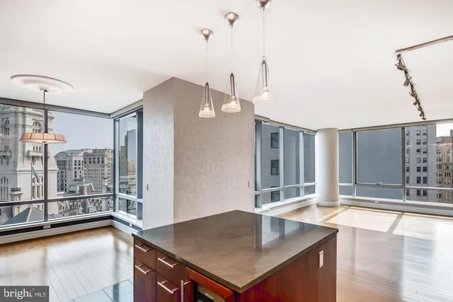 a kitchen with stainless steel appliances granite countertop a sink refrigerator and cabinets