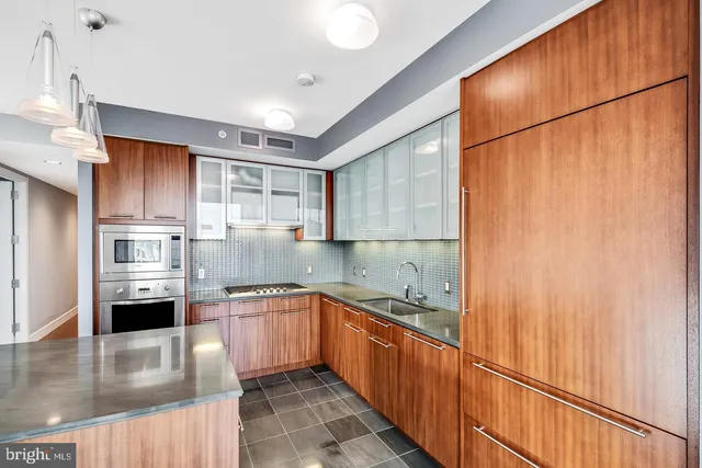 a kitchen with granite countertop a stove and a refrigerator
