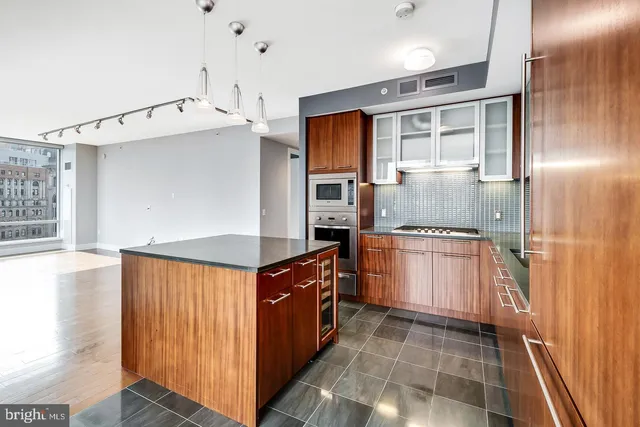 a view of a living room with a large window and chandelier
