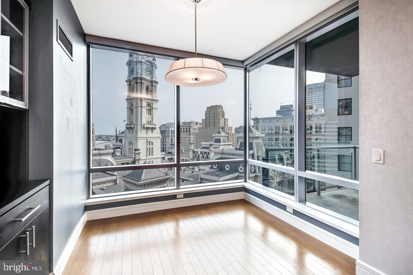 1414 South Penn Square, Unit 20B Philadelphia, PA 19102 - Photo 17 of 54 a view of a living room with a large window and chandelier