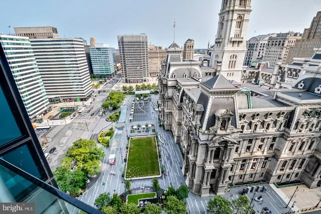 a spacious bedroom with a bed and a couch with outer view