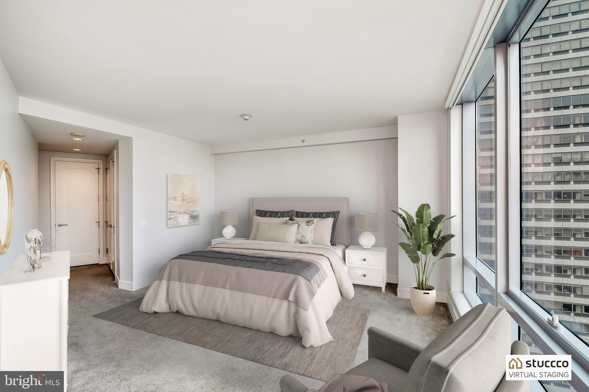 1414 South Penn Square, Unit 20B Philadelphia, PA 19102 - Photo 23 of 54 a bedroom with a large bed and a potted plant