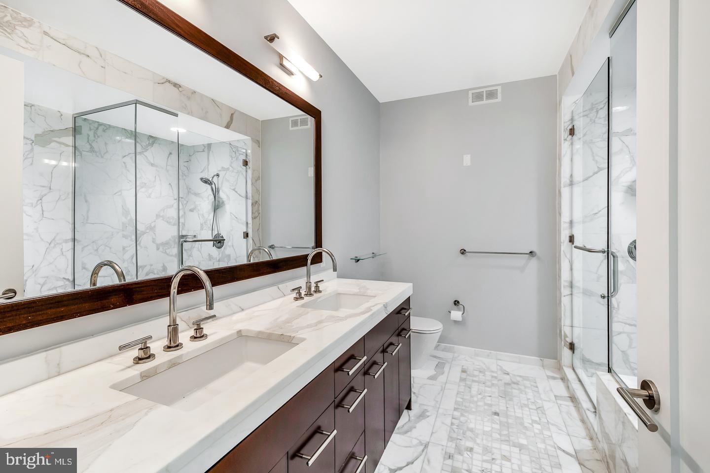 1414 South Penn Square, Unit 20B Philadelphia, PA 19102 - Photo 27 of 54 a bathroom with a double vanity sink mirror and double