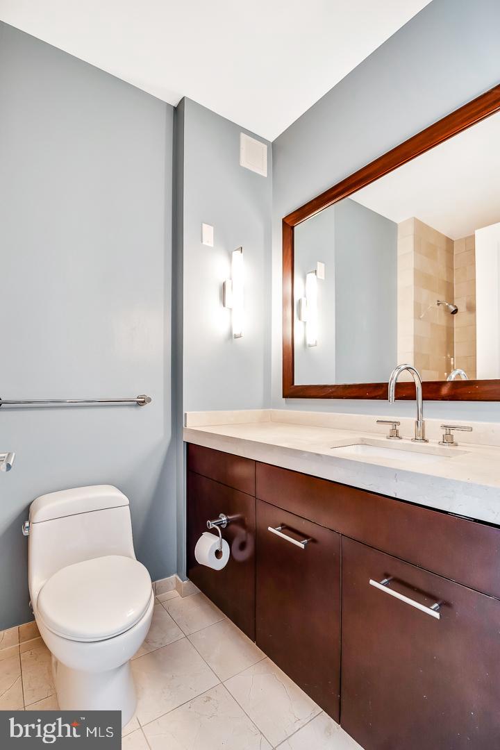 1414 South Penn Square, Unit 20B Philadelphia, PA 19102 - Photo 36 of 54 a bathroom with a sink a toilet and mirror