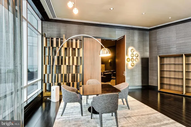 a room with lots of frames and a lamp