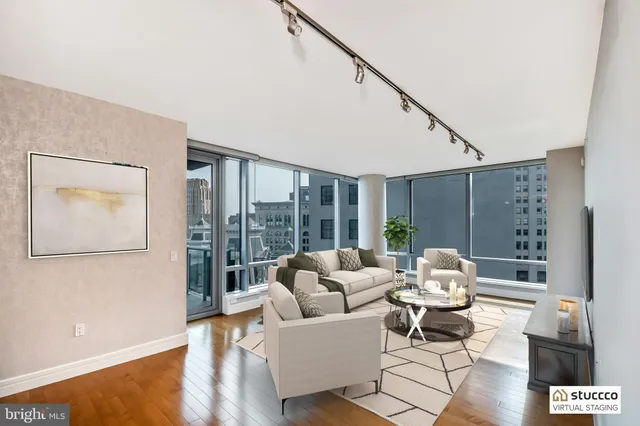 a living room with furniture and large windows