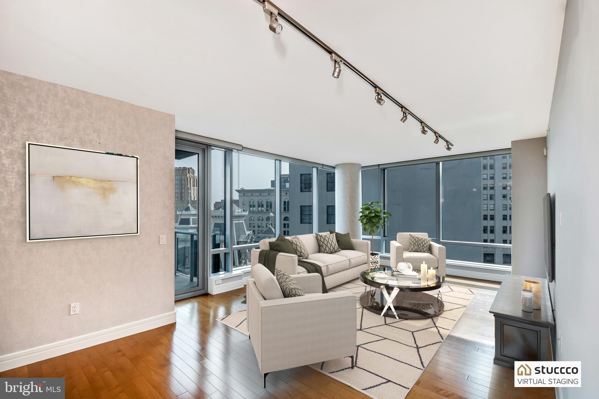 1414 South Penn Square, Unit 20B Philadelphia, PA 19102 - Photo 7 of 54 a living room with furniture and large windows