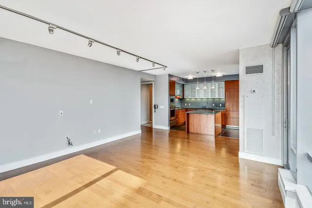 a view of a living room with furniture and floor to ceiling window