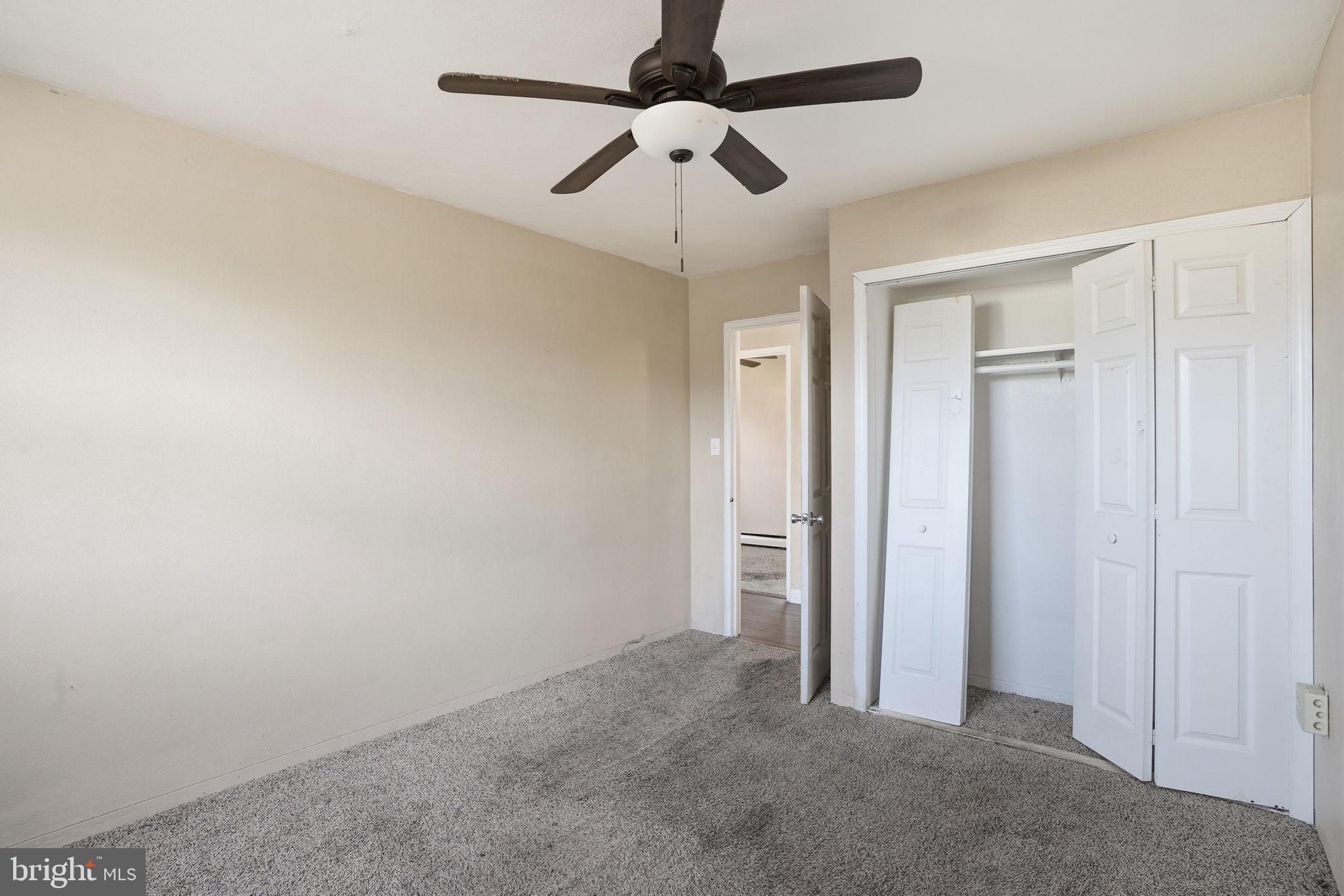 610 Wardour Road Glen Burnie, MD 21061 - Photo 14 of 19 an empty room with closet and a chandelier fan
