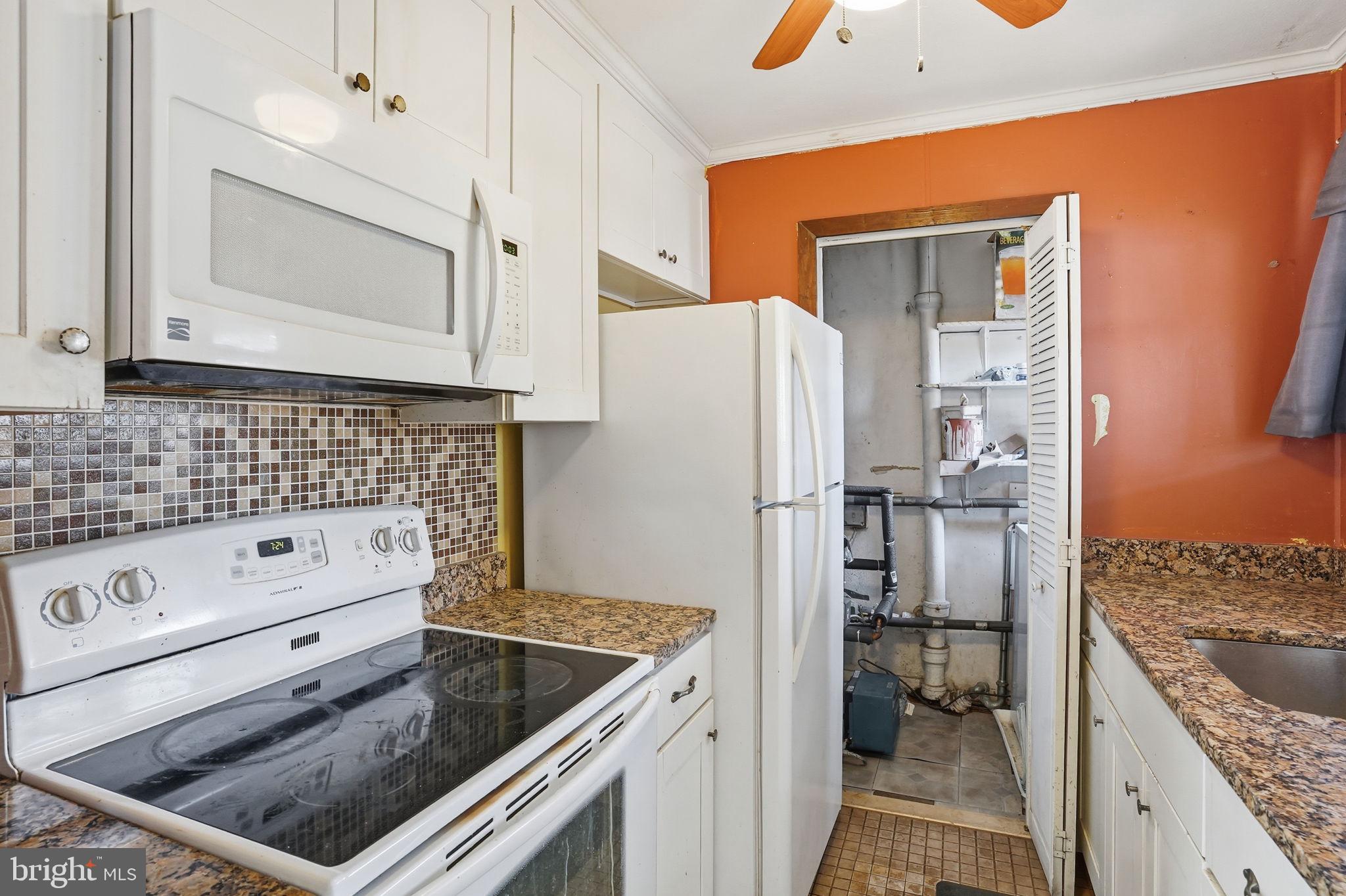 610 Wardour Road Glen Burnie, MD 21061 - Photo 3 of 19 a kitchen with a refrigerator and a stove